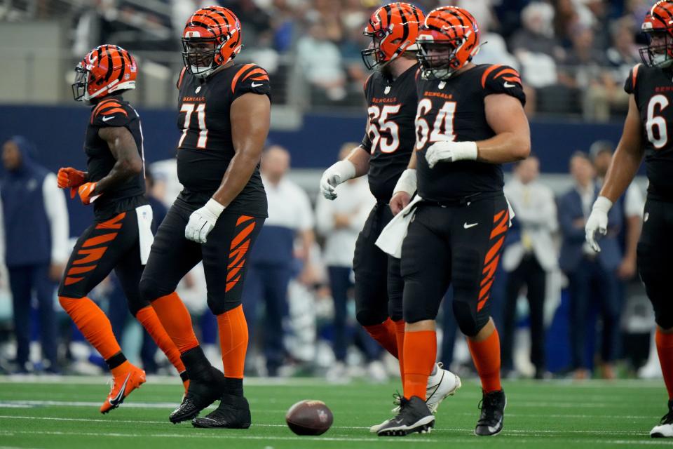 Cincinnati Bengals offensive tackle La'el Collins (71) and the Cincinnati Bengals offensive line come up to the line of scrimmage for a snap in the first quarter of an NFL Week 2 game against the Dallas Cowboys, Sunday, Sept. 18, 2022, at AT&T Stadium in Arlington, Texas.