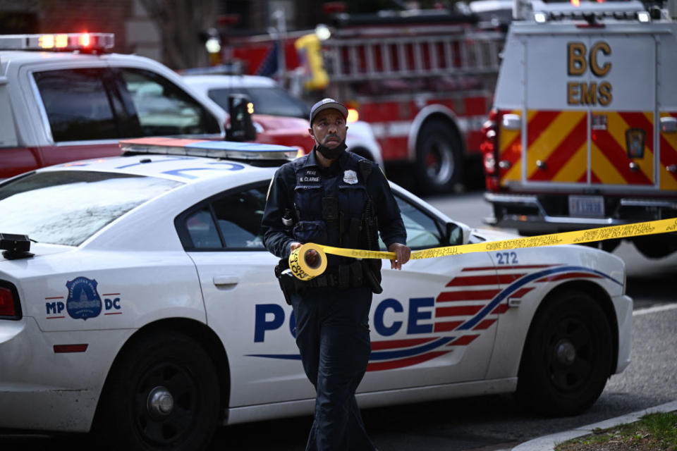 A police officer secures the area near Connecticut Avenue after an alleged shooting in Washington, D.C., April 22