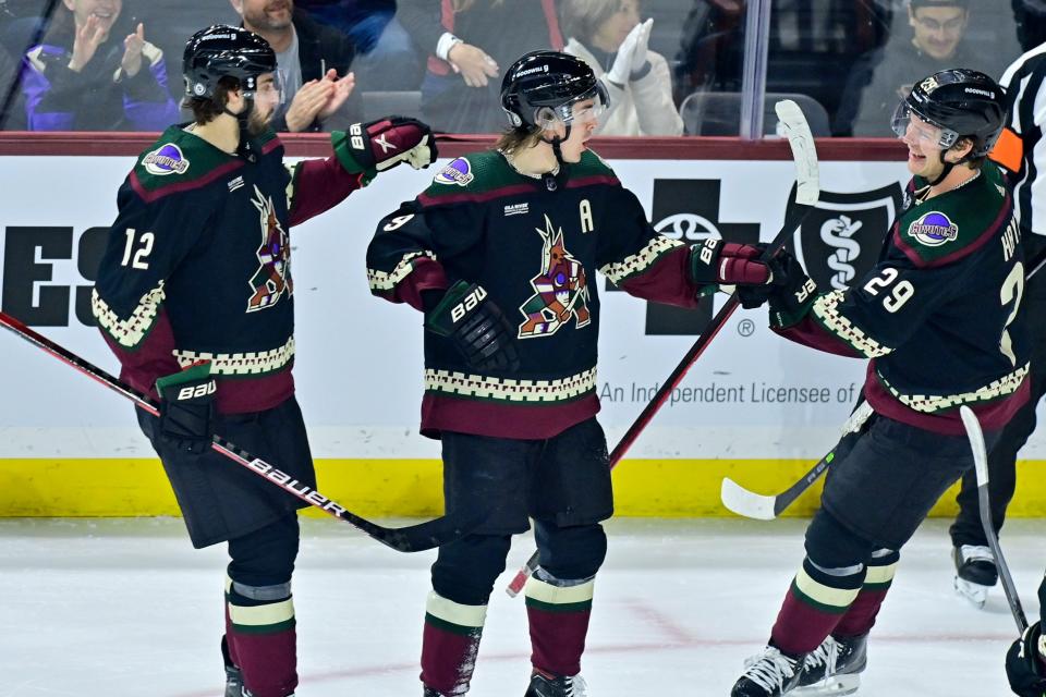 Arizona Coyotes right wing Clayton Keller (9) celebrates with defenseman Connor Mackey (12) and center Barrett Hayton (29) after scoring a goal in the third period against the St. Louis Blues at Mullett Arena in Tempe on March 7, 2023.