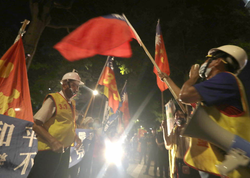 People protest outside the hotel where U.S. House Speaker Nancy Pelosi is supposed to be staying in Taipei, Taiwan, Tuesday, Aug 2, 2022. Pelosi arrived in Taiwan on Tuesday on a visit that could significantly escalate tensions with Beijing, which claims the self-ruled island as its own territory. (AP Photo/Chiang Ying-ying)