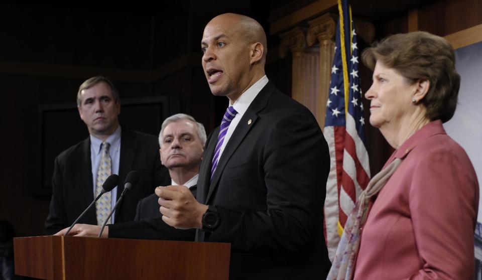 Sen. Cory Booker, D-N.J., second from right, speaks during a news conference to discuss unemployment insurance, Thursday, Feb. 6, 2014, on Capitol Hill in Washington. From left are, Sen. Jeff Merkley, D-Ore., Sen. Jack Reed, D-R.I., Booker and Sen. Jeanne Shaheen, D-N.H. (AP Photo/Susan Walsh)