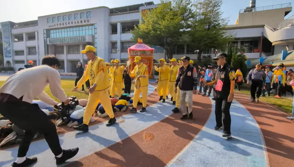 <strong>國小生們見媽祖前來興奮直奔操場，自動列隊趴地接福。（圖／翻攝自白沙屯媽祖網路電視台YouTube）</strong>