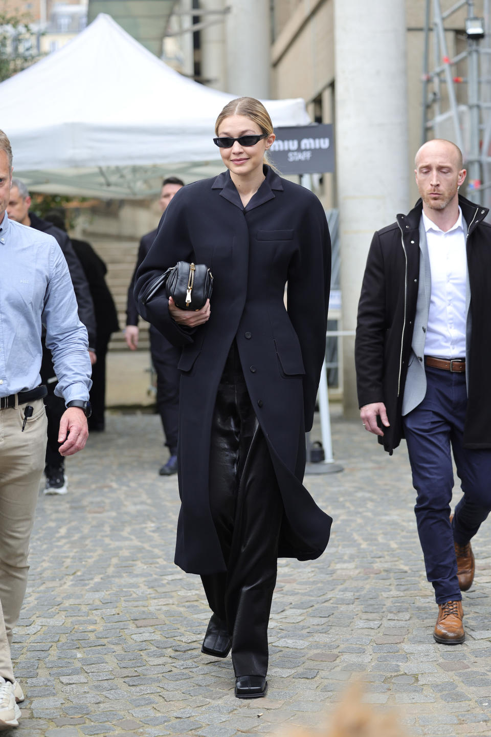 Gigi Hadid wearing an all-black outfit leaving the Miu Miu show