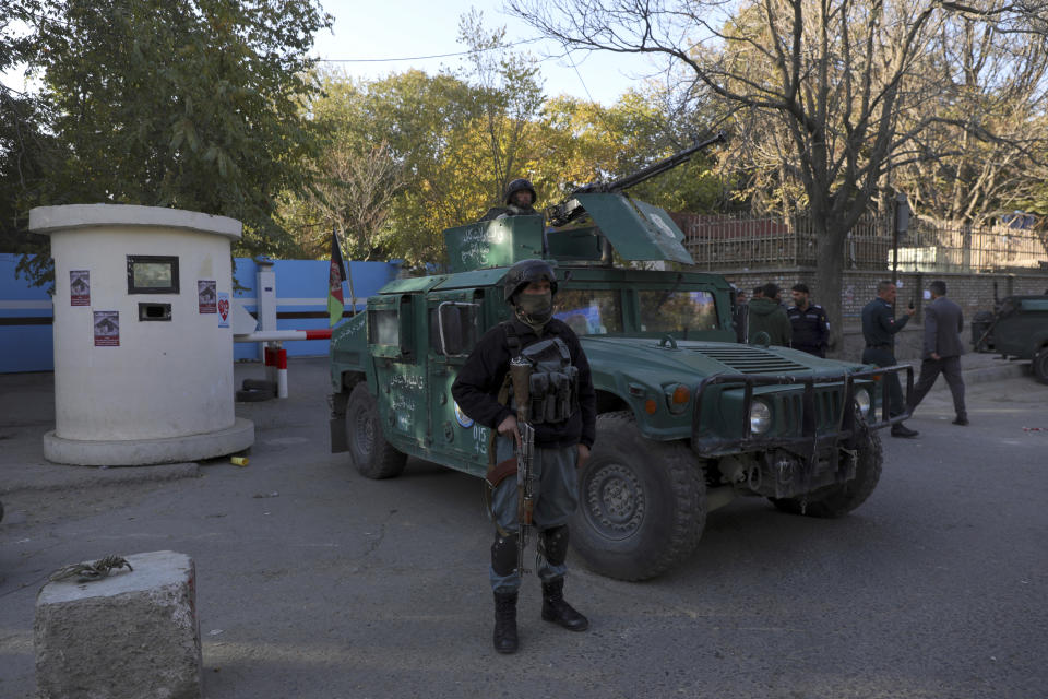 Afghan security police stand guard at the entrance gate of Kabul University after a deadly attack in Kabul, Afghanistan, Tuesday, Nov. 3, 2020. The brazen attack by gunmen who stormed the university has left many dead and wounded in the Afghan capital. The assault sparked an hours-long gun battle. (AP Photo/Rahmat Gul)