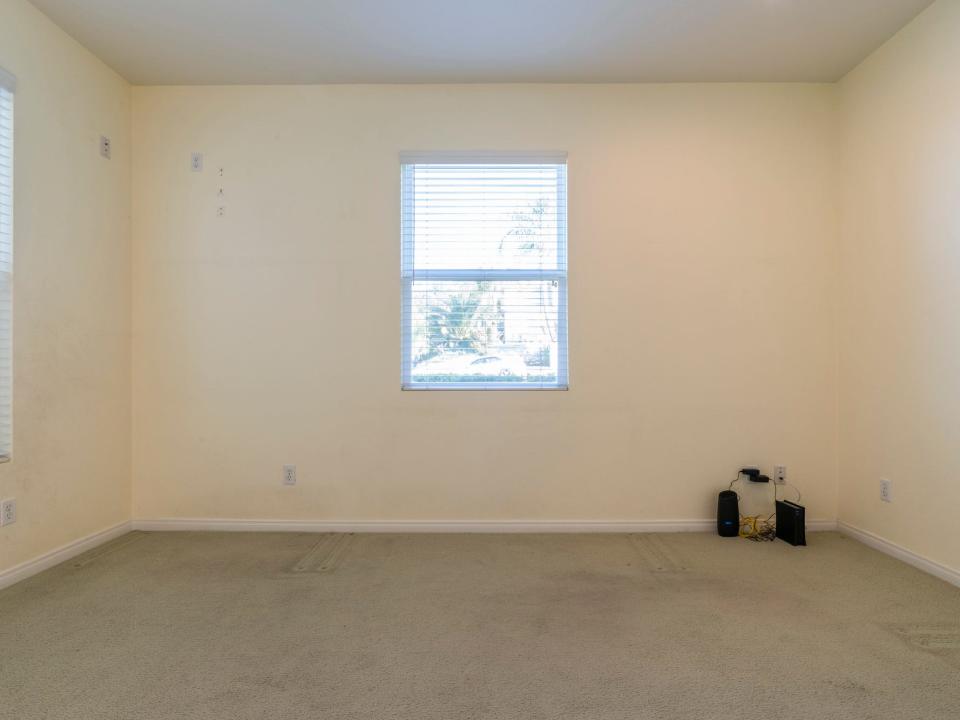 An empty room with yellow walls.