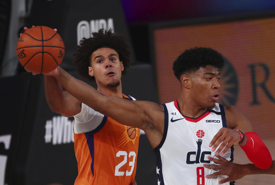 Washington Wizards forward Rui Hachimura (8) battles for the ball with Phoenix Suns forward Cameron Johnson (23) during the second half of an NBA basketball game Friday, July 31, 2020, in Lake Buena Vista, Fla. (Kim Klement/Pool Photo via AP)