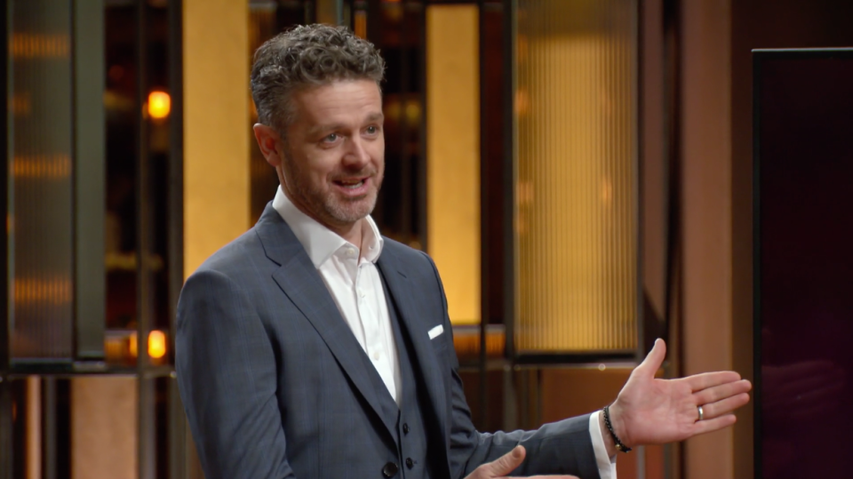 MasterChef judge Jock Zonfrillo wearing a navy suit on set