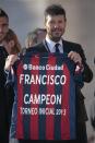 A member of Argentine soccer team San Lorenzo shows the jersey they presented to Pope Francis during the Wednesday general audience in Saint Peter's square at the Vatican December 18, 2013. REUTERS/Tony Gentile