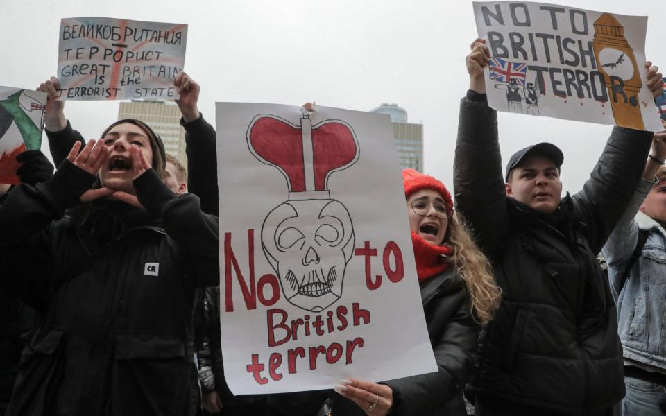 Protestors hold placards saying Britain is a terrorist state - MAXIM SHIPENKOV/EPA-EFE/Shutterstock/ Shutterstock