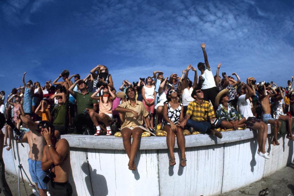 <p>Spectators as they watch (and film) the launch of NASA's Apollo 11 space mission from a concrete ledge at Cape Kennedy (later Cape Canaveral) on July 16, 1969.</p>