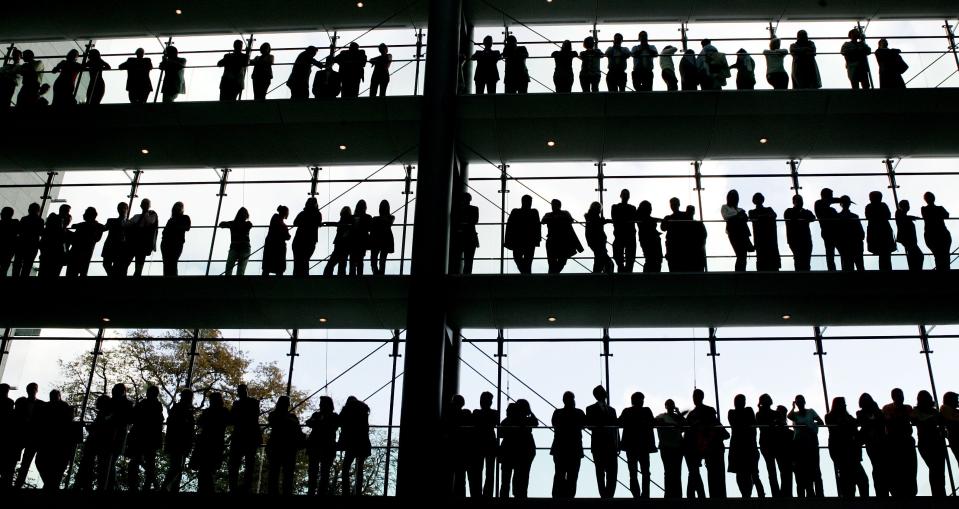 FILE - In this Oct. 30, 2007 file photo, employees are silhouetted at the Boehringer Ingelheim pharmaceutical factory in Ingelheim, central Germany. New statistics show unemployment in Germany fell unexpectedly in October, suggesting that Europe’s largest economy was beginning to shake off the negative impact of the coronavirus just as the pandemic started to spread rapidly again. (AP Photo/Michael Pobst, file)