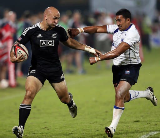 New Zealand's Dj J Forbes (L) fights for the ball with Samoa's Reupena Levasa during their International Rugby Board (IRB) Sevens World Series rugby union final match in Dubai. Samoa won 26-15