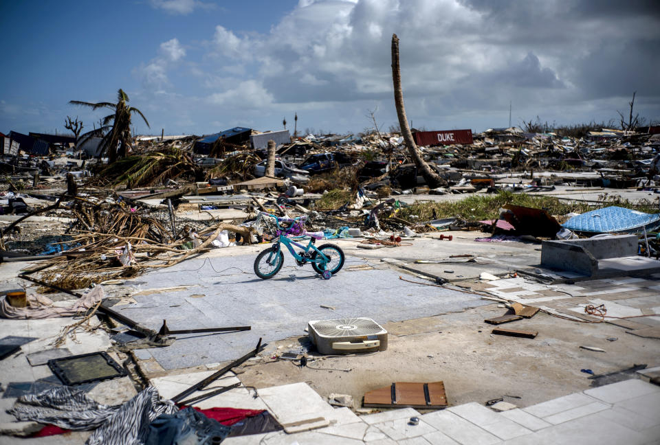 An abandoned bicycle stands in a space that used to be a house, in a neighborhood destroyed by Hurricane Dorian, in Abaco, Bahamas, Tuesday, Sept. 17, 2019. Dorian hit the northern Bahamas on Sept. 1, with sustained winds of 185 mph (295 kph), unleashing flooding that reached up to 25 feet (8 meters) in some areas. (AP Photo/Ramon Espinosa)