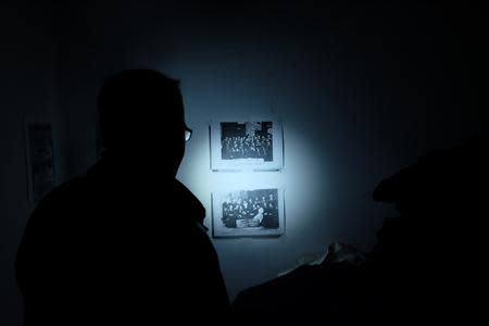 An employee shows pictures of former actors of Hamakom theater in Vienna in the second district of Vienna November 4, 2013. November 9th marks the 75th anniversary of the 'Kristallnacht' ('crystal night' or also referred to as 'night of broken glass') when Nazi thugs conducted a wave of violent anti-Jewish pogroms on the streets of Vienna and other cities in 1938 in Austria and Germany. Picture taken November 4, 2013. REUTERS/Leonhard Foeger