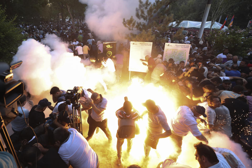 CORRECTS BYLINE - A police stun grenade explodes during a rally against Prime Minister Nikol Pashinyan in Yerevan, Armenia, Wednesday, June 12, 2024. (Vahram Baghdasaryan/Photolure via AP)
