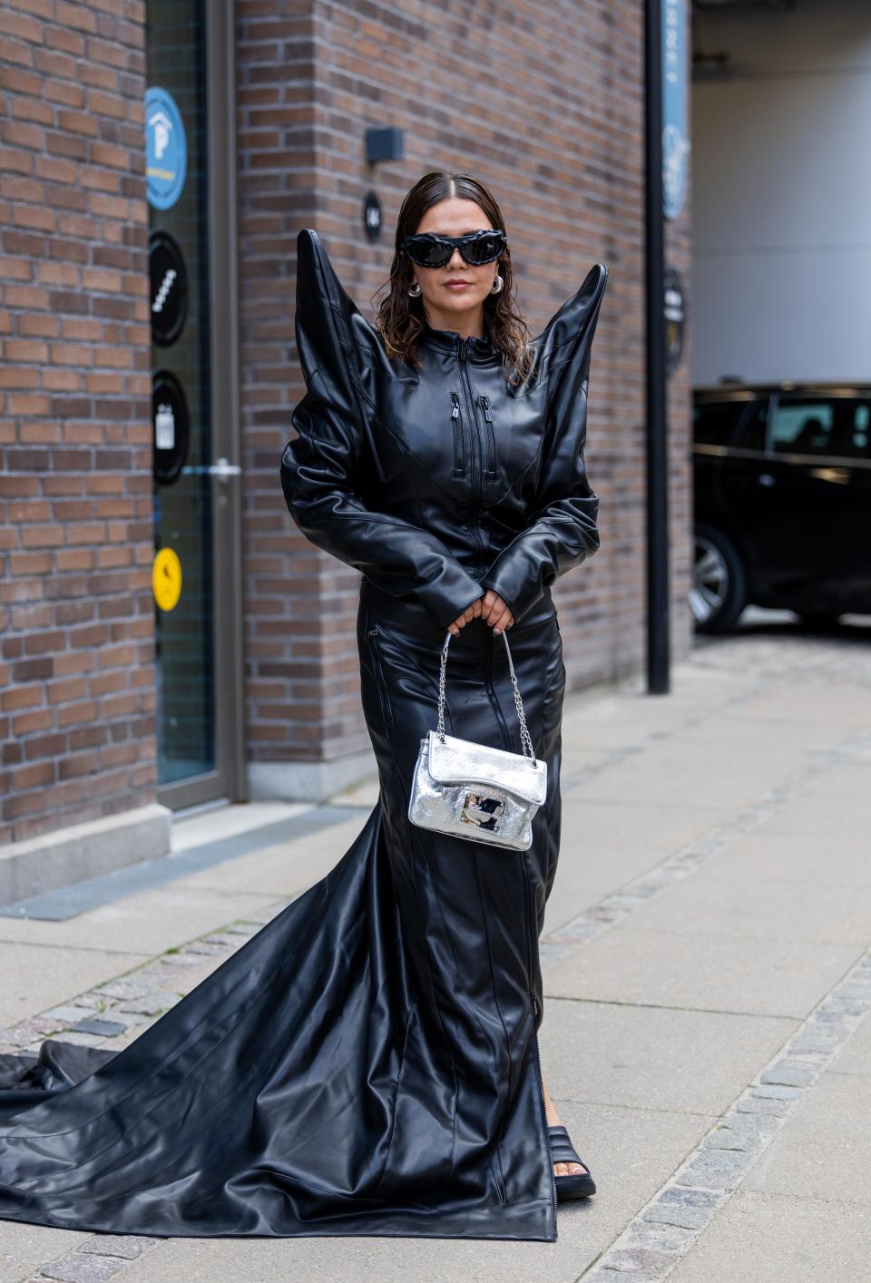 Amelia Stanescu in a maxi black leather dress with statement shoulder details