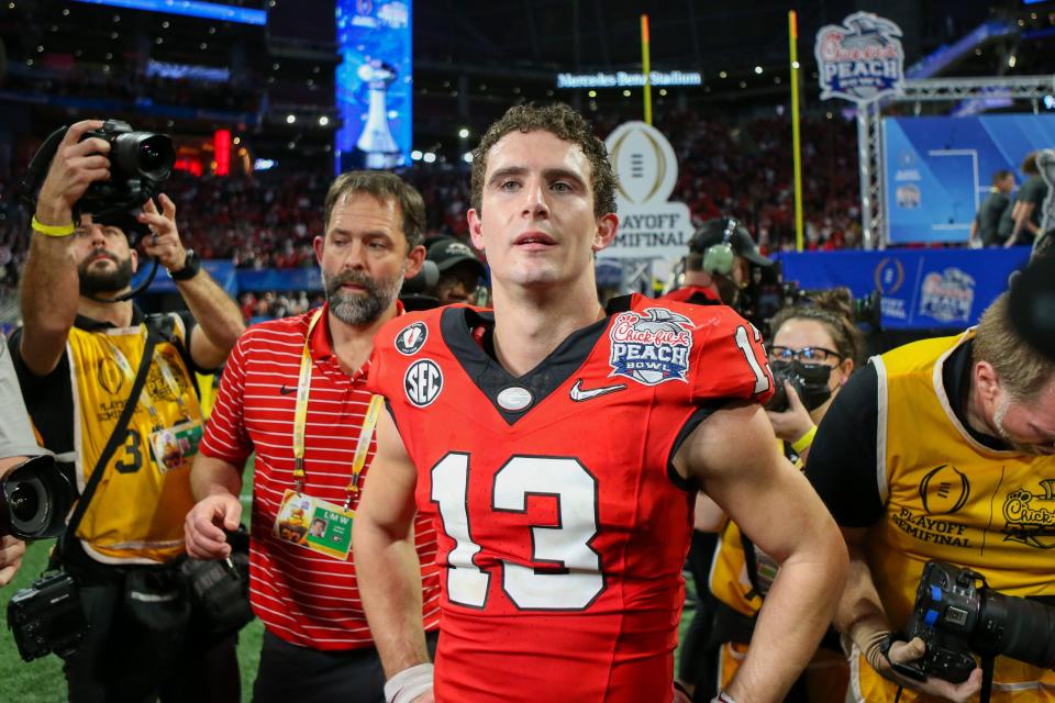 Georgia Bulldogs quarterback Stetson Bennett (13) celebrates after a victory against the Ohio State Buckeyes in the 2022 Peach Bowl at Mercedes-Benz Stadium.