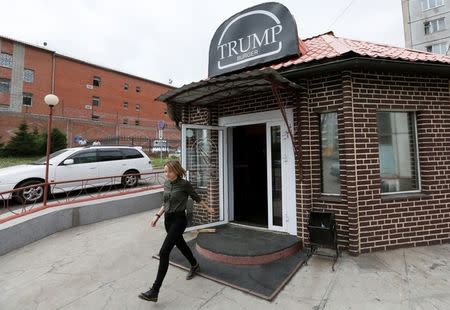 A visitor walks out of Trump Burger, a new Russian diner named after U.S. President Donald Trump, with a detention centre seen in the background, in Krasnoyarsk, Russia July 17, 2018. Picture taken July 17, 2018. REUTERS/Ilya Naymushin