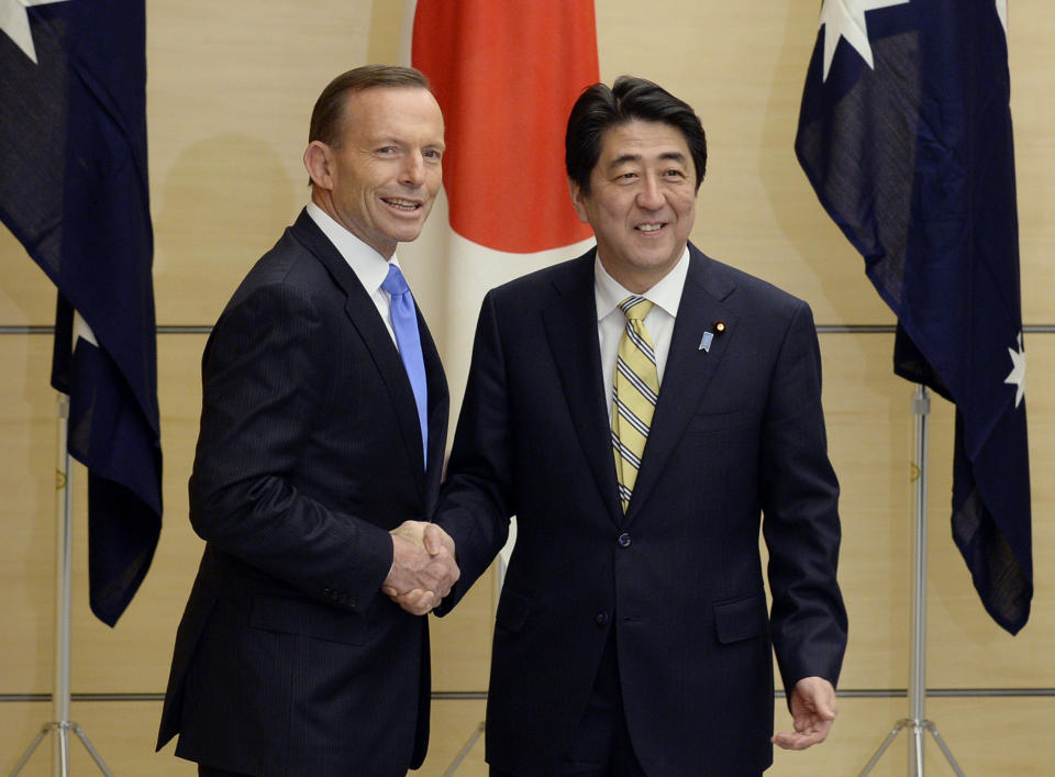 Australian Prime Minister Tony Abbott, left, and his Japanese counterpart Shinzo Abe shake hands prior to a National Security Council meeting at the latter's official residence in Tokyo Monday, April 7, 2014. It is the first time that a foreign leader attends to the meeting. Abbott is currently on a four-day official visit in Japan. (AP Photo/Franck Robichon, Pool)