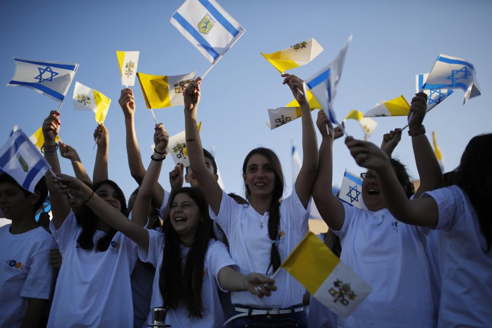 Israeli children hold up flags as they greet Pope Francis on Mount Scopus in Jerusalem