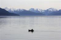 A fisherman paddles the waters of the Kitimat Arm of the Douglas Channel in his canoe in northern British Columbia near to where Enbridge Inc plans to build its Northern Gateway pipeline terminal facility April 13, 2014. REUTERS/Julie Gordon