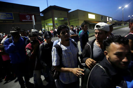 A large group of Hondurans fleeing poverty and violence, move in a caravan toward the United States, in San Pedro Sula, Honduras October 13, 2018. REUTERS/Jorge Cabrera