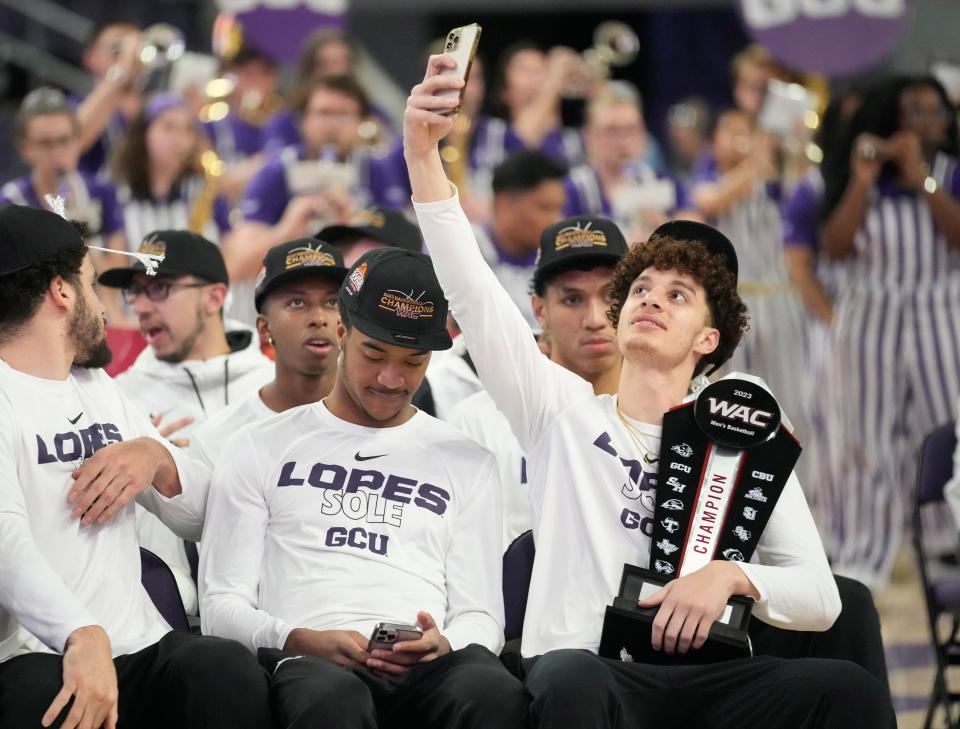 Grand Canyon guard Walter Ellis takes a photo during an NCAA Selection Show watch party at GCU Arena on March 12, 2023.