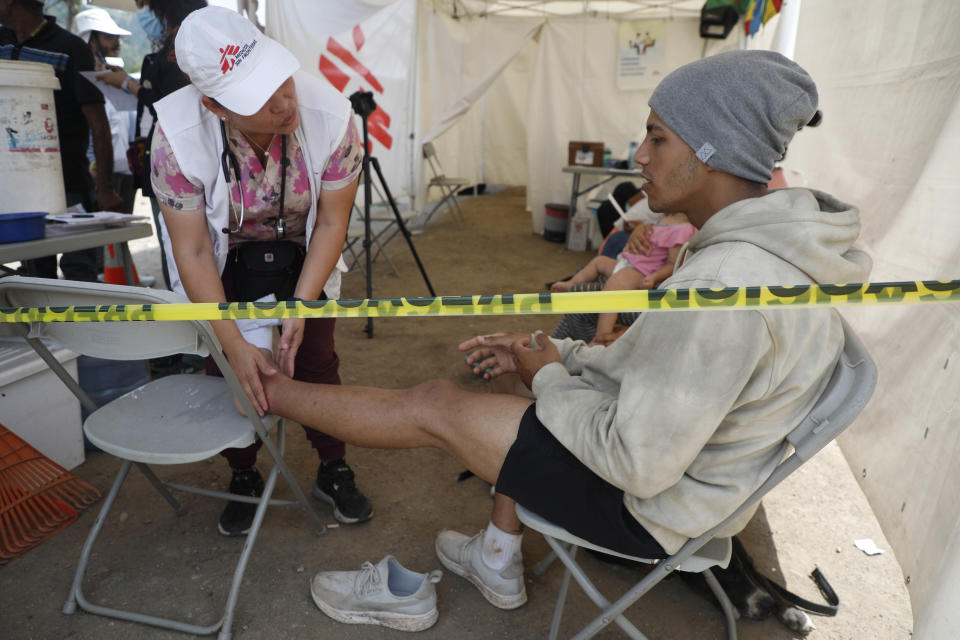 A migrant from Venezuela is aided by a volunteer at a refugee shelter in Danlí, Honduras, Wednesday, Oct. 11, 2023. According to Honduras' immigration agency, at the country's southern border with Nicaragua, more than 18,300 migrants entered the town last week. (AP Photo/Elmer Martinez)