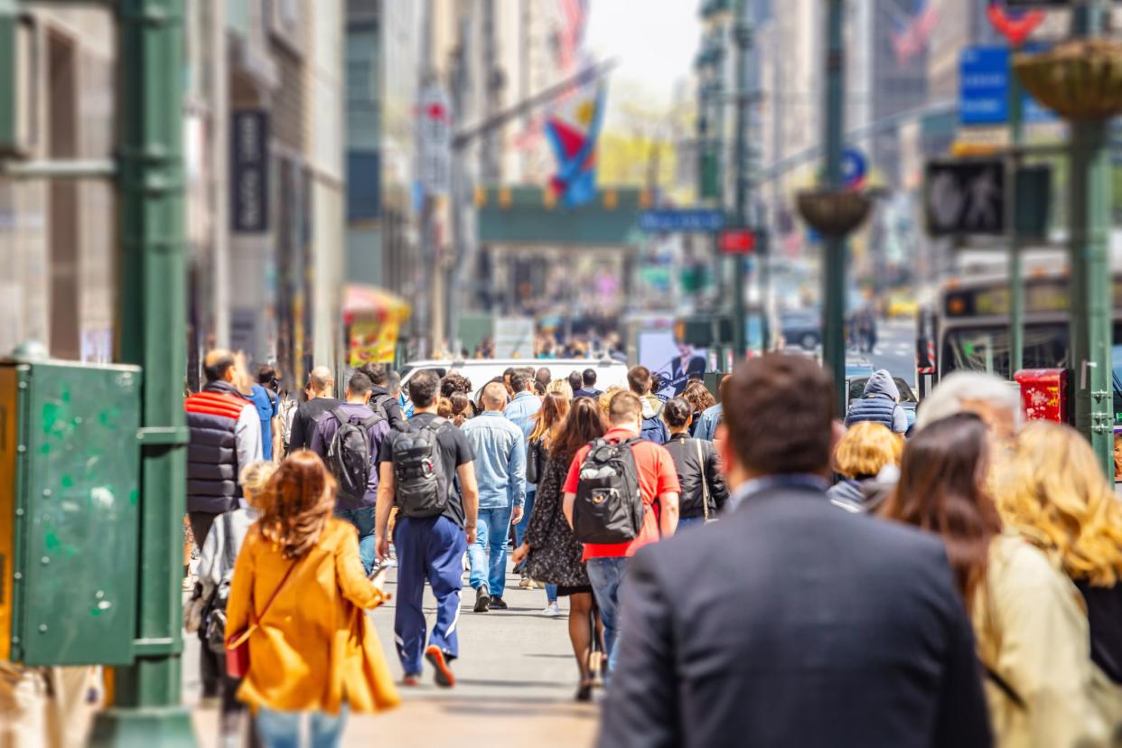 USA, New York, Manhattan streets. Skyscrapers and crowded streets, cars and busy people walking downtown in a spring sunny day