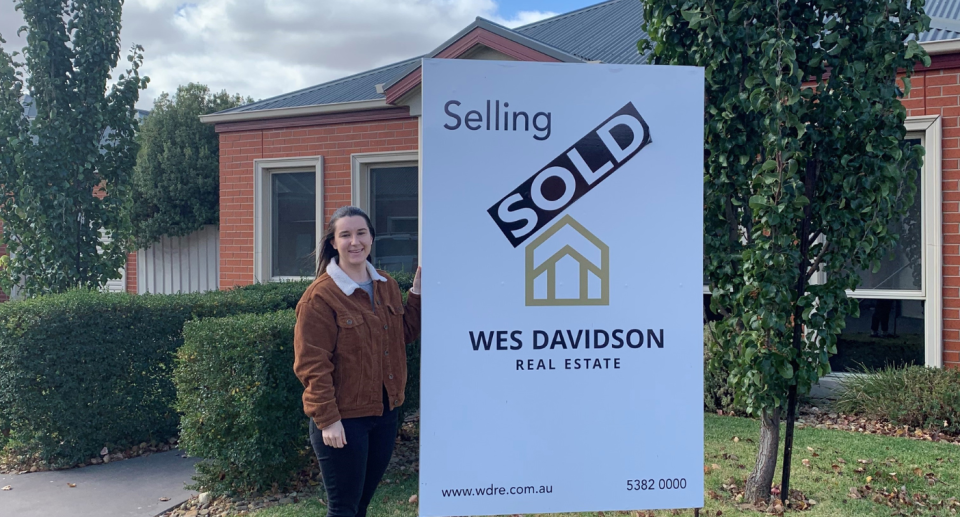 Emily Simpson rentvesting with investment property sale sign.