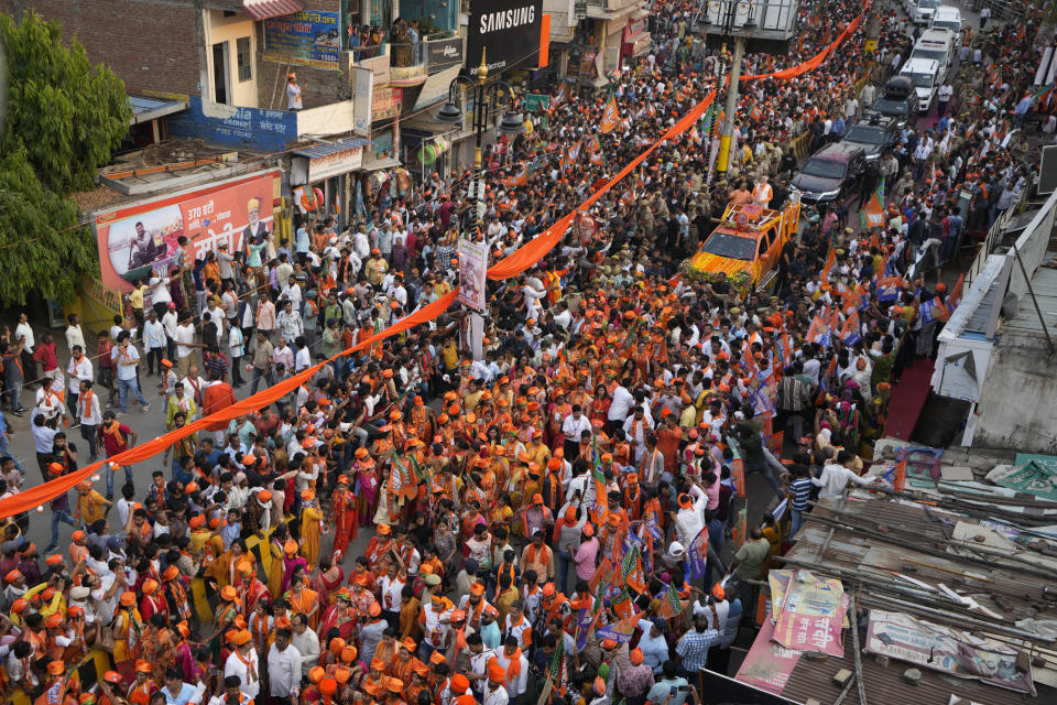 Supporters of Bharatiya Janata Party(BJP) participate in a roadshow by Indian Prime Minister Narendra Modi in Varanasi, India, Monday, May 13, 2024. (AP Photo/Rajesh Kumar)