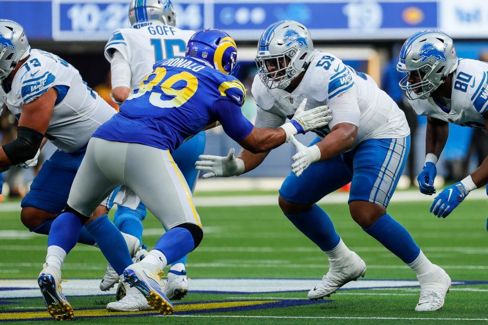 Detroit Lions offensive tackle Penei Sewell (58) tries to block Los Angeles Rams defensive end Aaron Donald (99) during the second half at the SoFi Stadium in Inglewood, Calif. on Sunday, Oct. 24, 2021.
