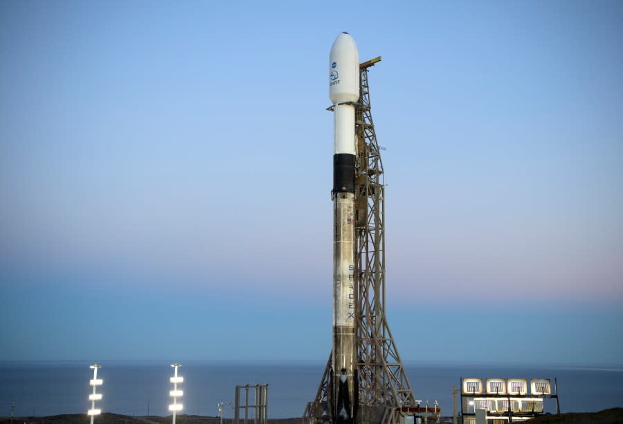 In this image provided by NASA, a SpaceX Falcon 9 rocket with the Double Asteroid Redirection Test, or DART, spacecraft onboard, sits during sunrise, Tuesday, Nov. 23, 2021, at Space Launch Complex 4E, Vandenberg Space Force Base, Calif. (Bill Ingalls/NASA via AP)