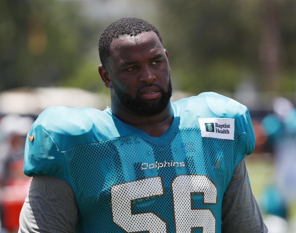 FILE - In this July 30, 2019, file photo, Miami Dolphins defensive tackle Davon Godchaux walks off the field after the teams NFL football training camp in Davie, Fla. A person familiar with the deal says the New England Patriots have come to terms with free agent defensive tackle Godchaux on a two-year, $16 million deal with $9 million guaranteed. (AP Photo/Wilfredo Lee, File)