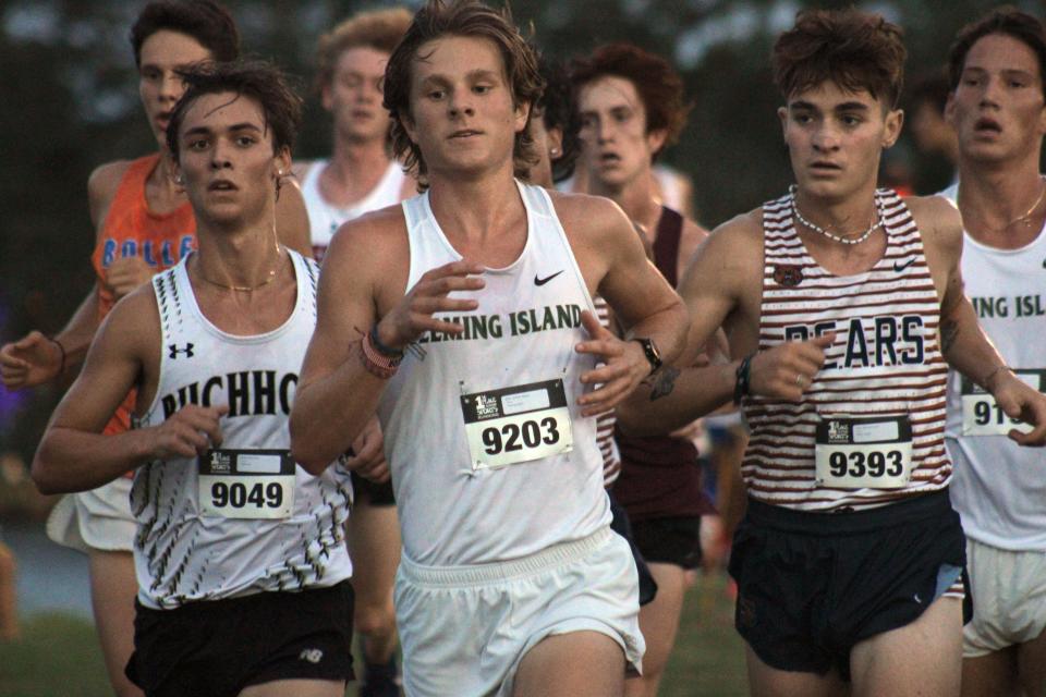 Gainesville Buchholz's Riley Smith (9049), Fleming Island's Graham Myers (9203) and Mater Lakes' Marc Gonzalez (9393) lead the pack early in the boys elite high school cross country race at the Katie Caples Invitational on September 16, 2023. [Clayton Freeman/Florida Times-Union]