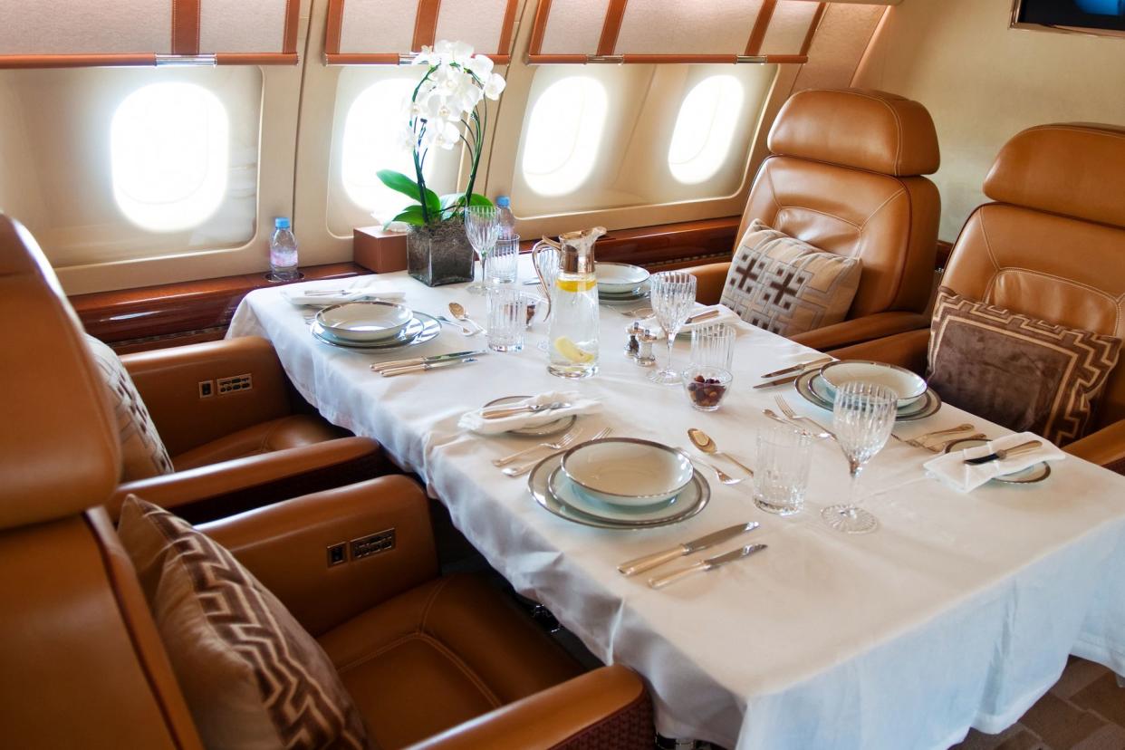 white flowers on business airplane table with comfy leather chairs