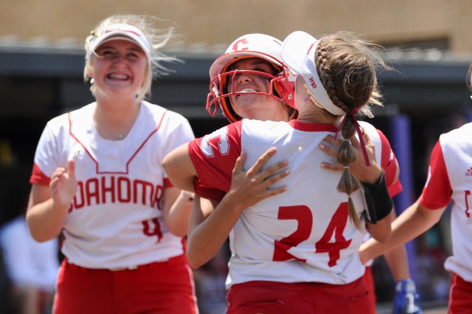 Coahoma's Brynn Rodgers (right) congratulates Madison Rodgers after she hit a home run against Holliday on Saturday.