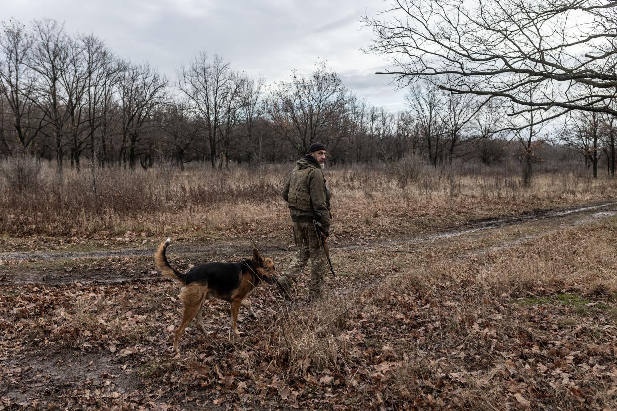 Ukrainian soldier walks with his dog towards his fighting position in the direction of Gorlivka, as Russia-Ukraine war continues in Donetsk Oblast (Anadolu via Getty Images)