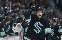 Seattle Kraken forward Shane Wright reacts after scoring a goal against the Montreal Canadiens during the first period of an NHL hockey game, Tuesday, Dec. 6, 2022, in Seattle. (AP Photo/Stephen Brashear)