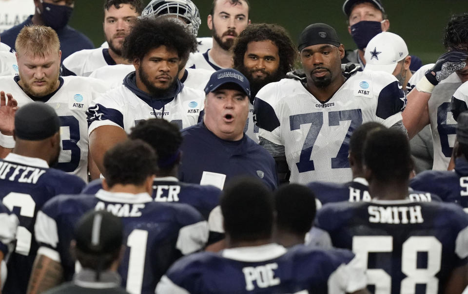 Dallas Cowboys head coach Mike McCarthy, center, speaks to the team during NFL football training camp in Frisco, Texas, Tuesday, Aug. 18, 2020. (AP Photo/LM Otero)