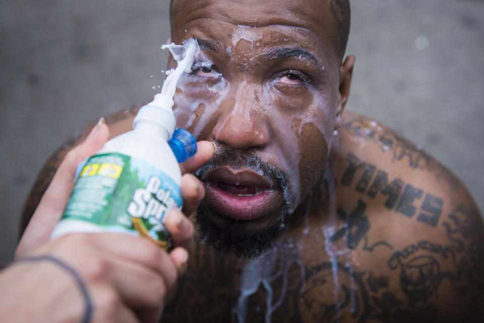BALTIMORE, MD - APRIL 27: A man who was pepper sprayed has his eyes washed out near West North Avenue and Pennsylvania Avenue during a protest for Freddie Gray in Baltimore, MD on Monday April 27, 2015. Gray died from spinal injuries about a week after he was arrested and transported in a police van. (Photo by Jabin Botsford/The Washington Post via Getty Images)