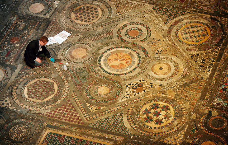 LONDON - MAY 06:  Stone restorer Nicholas Hague cleans Westminster Abbey's Cosmati Pavement on May 6, 2008 in London, England. Centuries of dirt and grime will be painstakingly removed from this work of medieval craftsmanship during a 535,000 GBP restoration project. The 56 sq/m intricate mosaic floor lies in front of the High Altar. Long hidden under rolls of carpet,  it is made from small inlaid pieces of semi-precious stone, marble, glass and metal set in squares and circles some of which is thought to have been recycled from the ruins of ancient Rome. Commissioned by Henry III to be a centrepiece of the re-built 13th century Abbey.  (Photo by Peter Macdiarmid/Getty Images)