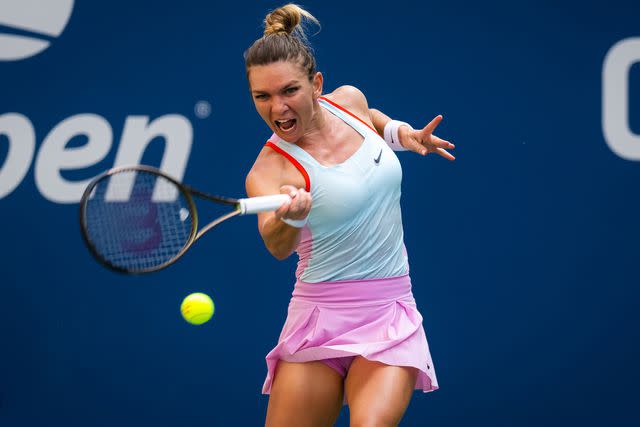 <p>Robert Prange/Getty </p> Simona Halep hits a shot at the 2022 US Open