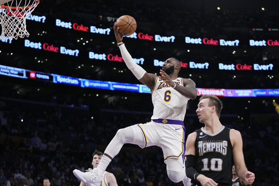 Los Angeles Lakers forward LeBron James, left, shoots as Memphis Grizzlies guard Luke Kennard defends during the first half in Game 3 of a first-round NBA basketball playoff series Saturday, April 22, 2023, in Los Angeles. (AP Photo/Mark J. Terrill)