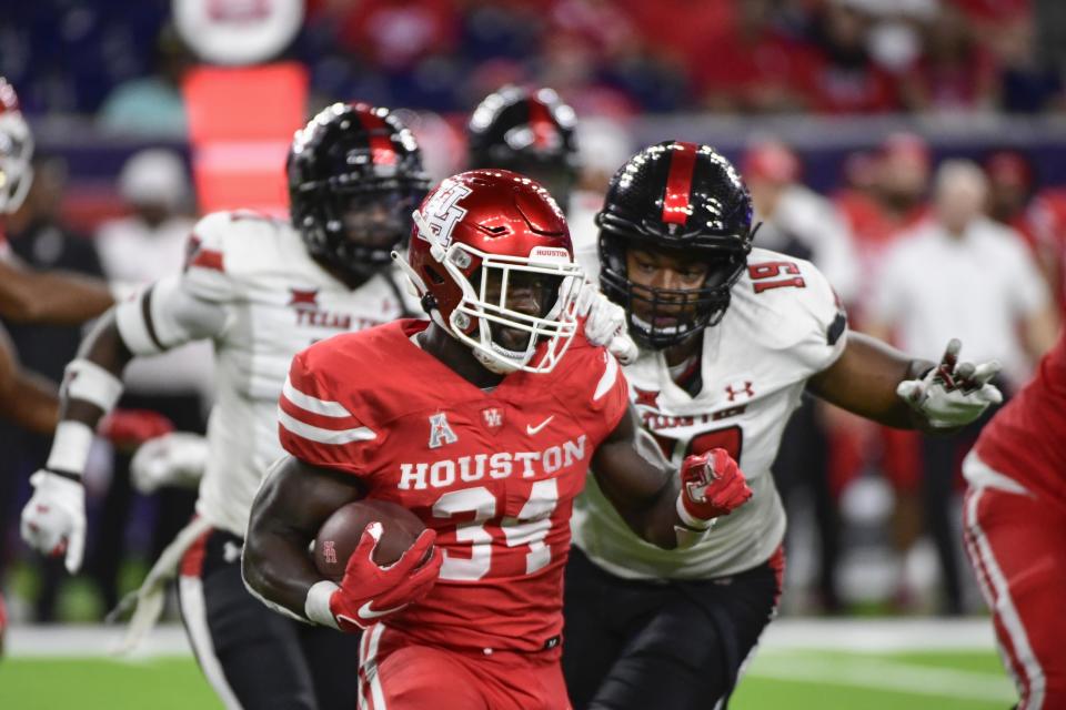 Houston running back Mulbah Car (34) runs the ball against Texas Tech during the second half of an NCAA college football game Saturday, Sept. 4, 2021, in Houston. (AP Photo/Justin Rex)