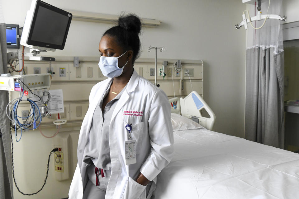 Dr. Meshia Wallace, a pulmonary physician who works in critical care at East Alabama Medical Center, talks about her experiences treating COVID-19 patients Thursday, Dec. 10, 2020, in Opelika, Ala. Amid so much suffering and after so many tears, any ray of brightness helps, even if it’s just a candy cane sticker on a ICU window, said Wallace. (AP Photo/Julie Bennett)