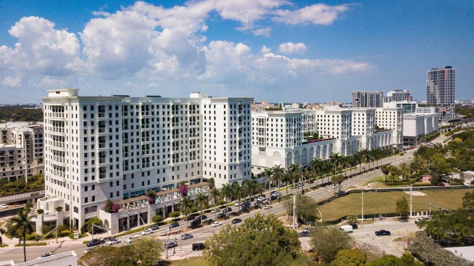 The towers of the wellness-oriented Life Time Coral Gables residential and retail complex stretch along U.S. 1 and the elevated Metrorail tracks. The new Cascade apartment tower at the Douglas Road Metrorail station is visible at top right.