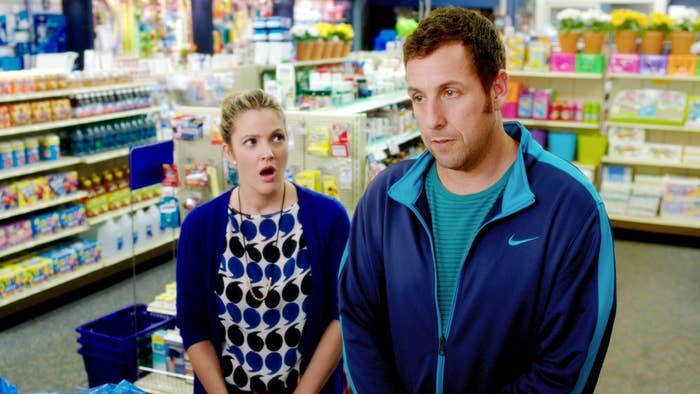 Drew Barrymore looking shocked at Adam Sandler.