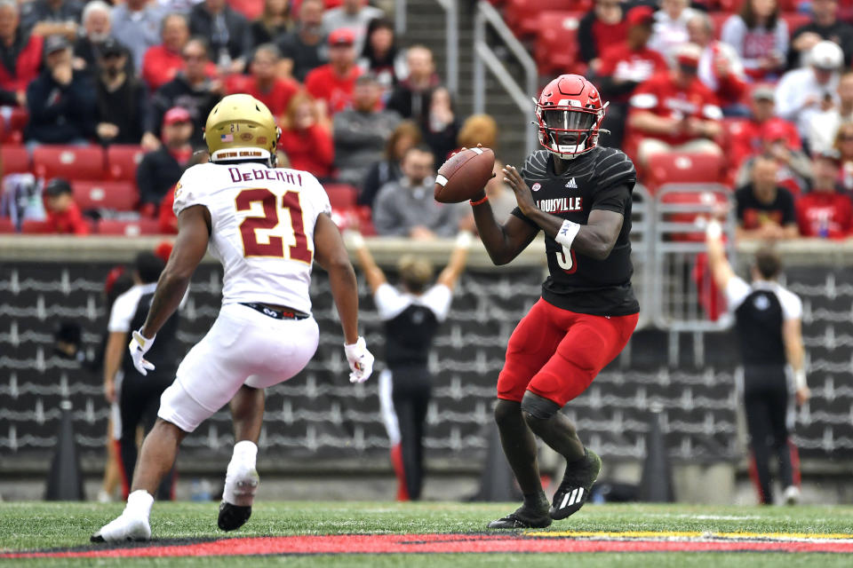 Louisville quarterback Malik Cunningham (3) attempts a pass while being pressured by Boston College defensive back Josh DeBerry (21) during the first half of an NCAA college football game in Louisville, Ky., Saturday, Oct. 23, 2021. (AP Photo/Timothy D. Easley)