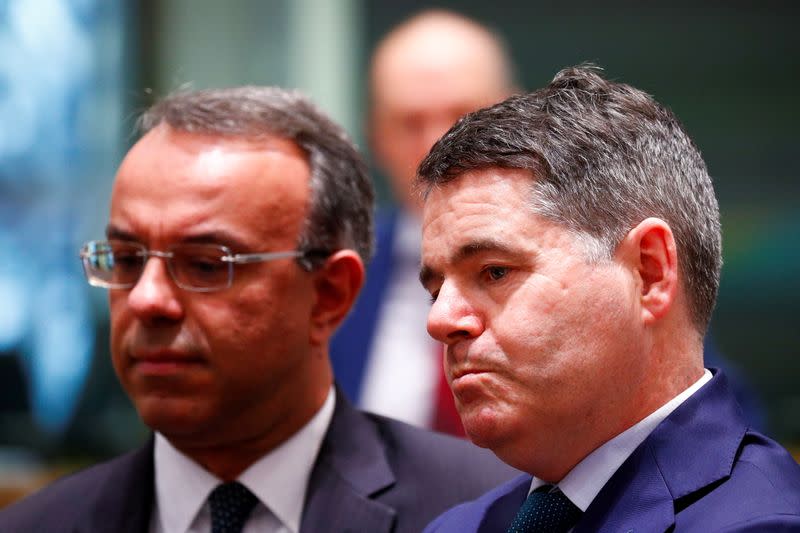 FILE PHOTO: Irish Finance Minister Paschal Donohoe (R) and Greek Finance Minister Christos Staikouras attend a Euro zone finance ministers meeting in Brussels